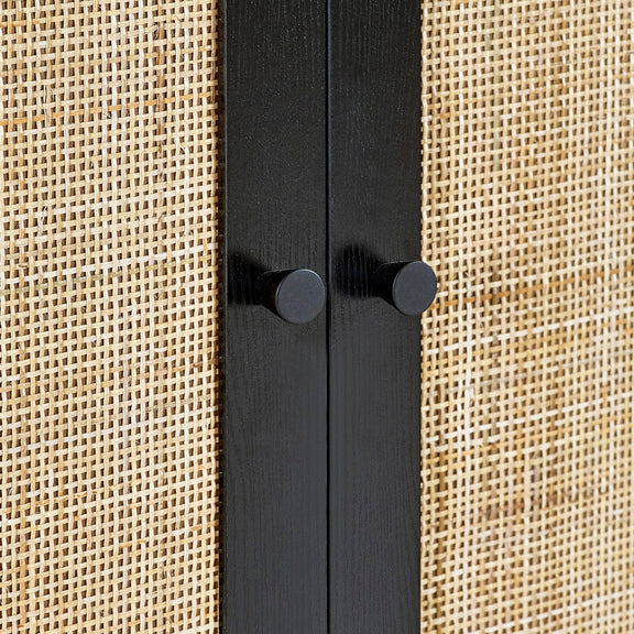 Black metal rod with two knobs on a beige textured background
