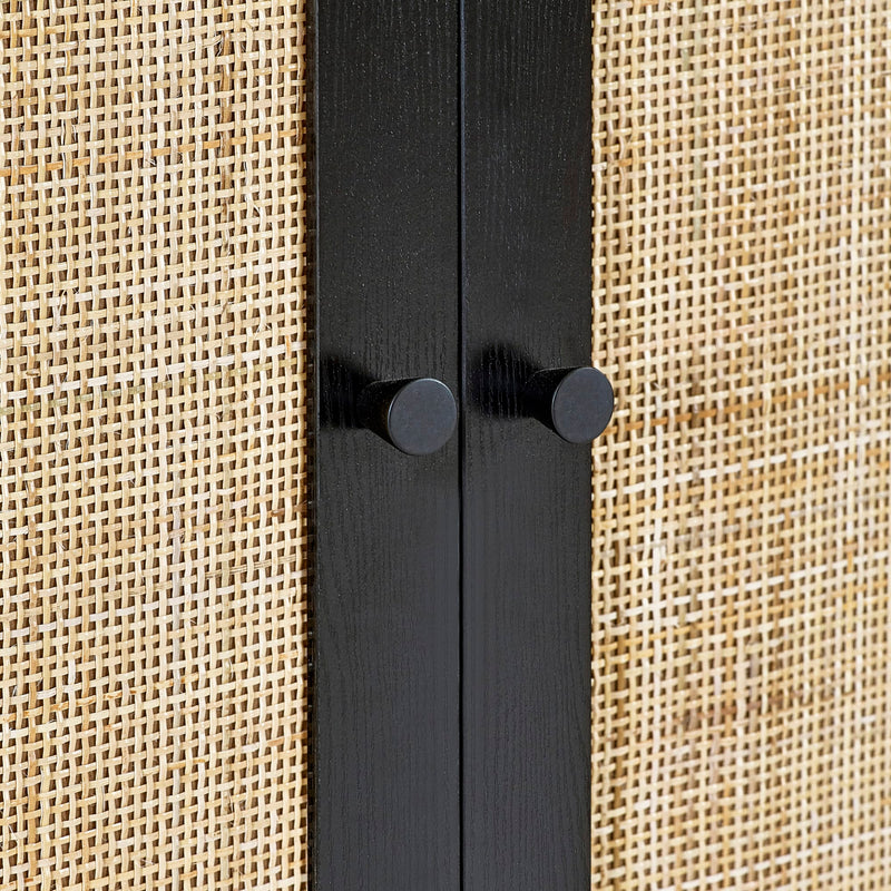 Black metal rod with two knobs on a beige textured background