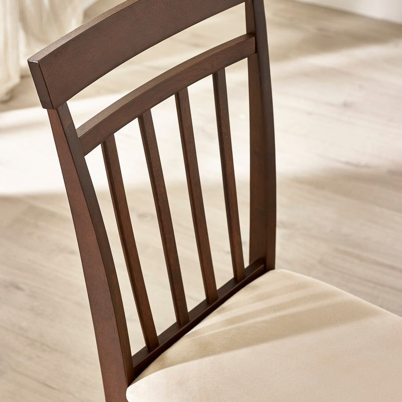 Brown wooden chair with a beige cushion on a light wooden floor.