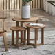 Set of wooden side tables with a vase and book on a rug