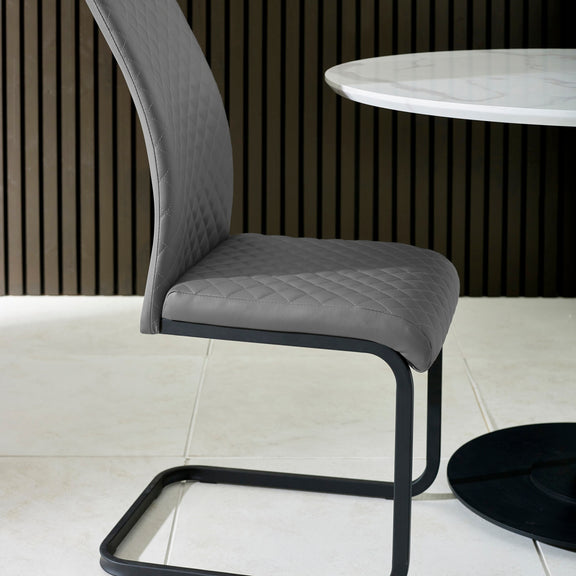 Gray chair with quilted seat design in a minimalistic setting