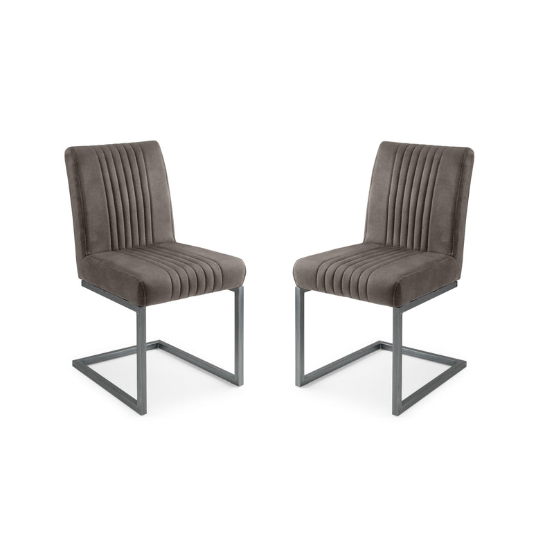 Two brown upholstered chairs with metal legs on a white background
