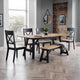 Dining room with a wooden table and chairs in a modern interior setting.