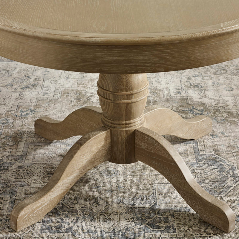 Wooden pedestal table on a patterned rug