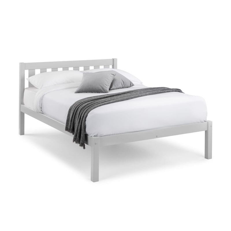 White bed frame with white bedding and gray blanket on a white background