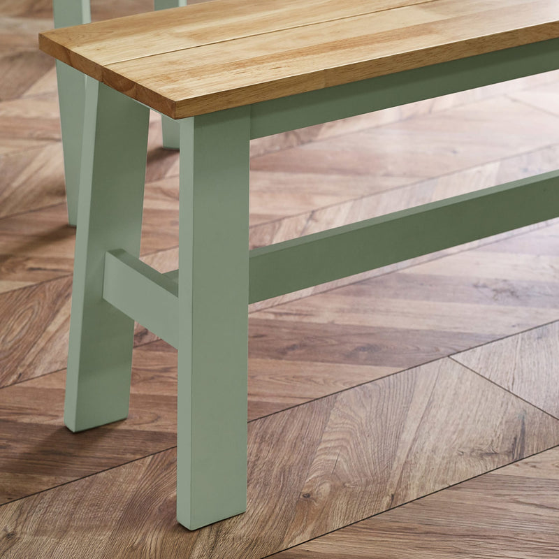 Wooden table with green legs on a wooden floor