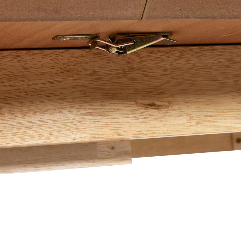 Close-up of a wooden drawer with a gold metal handle on a white background