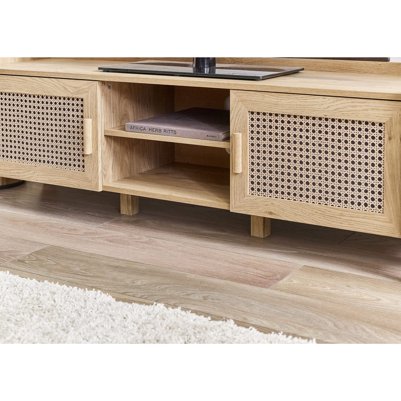 Wooden TV stand with rattan-style doors on a wooden floor.