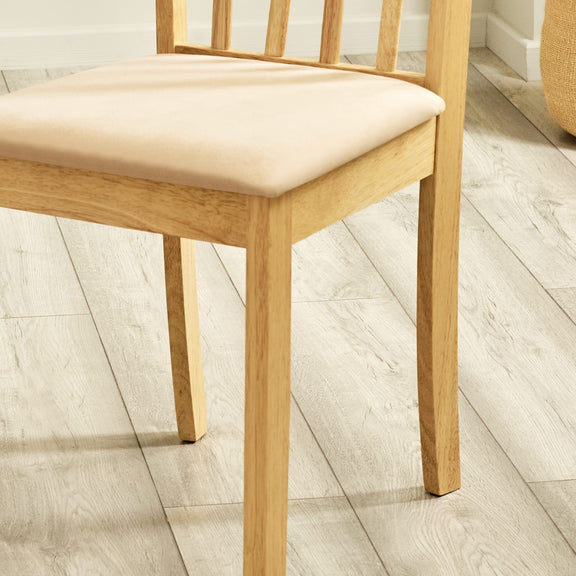 Wooden chair with beige cushion on a wooden floor