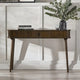 Wooden console table with decorative items against a white wall