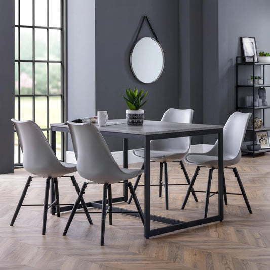 Dining room with a black rectangular table and four gray chairs against a gray wall.