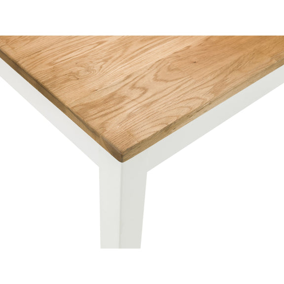 Wooden table top with white legs on a white background