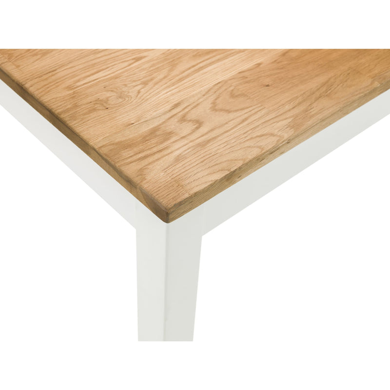 Wooden table top with white legs on a white background