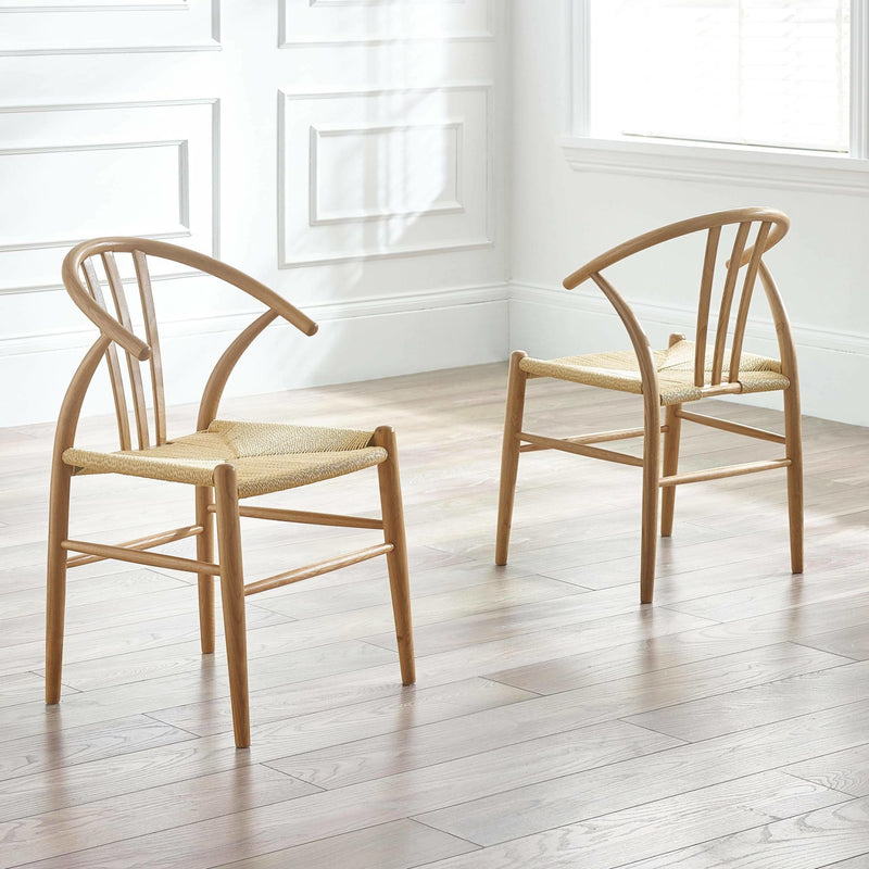 Two wooden chairs with woven seats in a bright room with white walls and wooden floor.