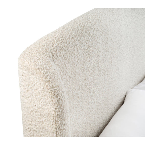 Close-up of a textured beige armchair corner on a white background