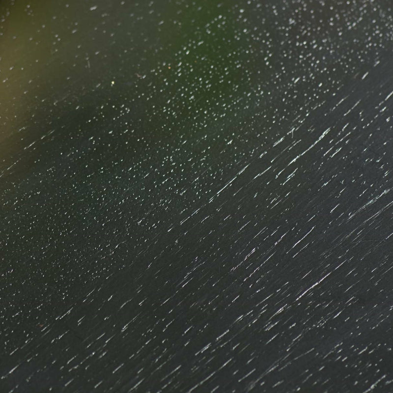 Close-up of raindrops on a dark surface