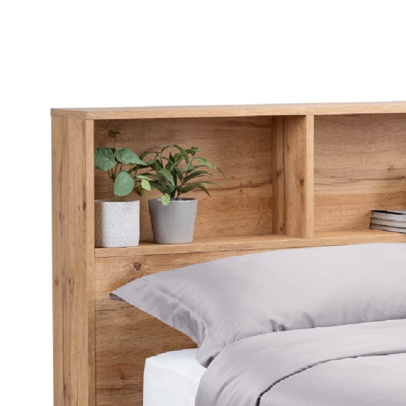 Wooden headboard with built-in shelves holding plants and books on a white background