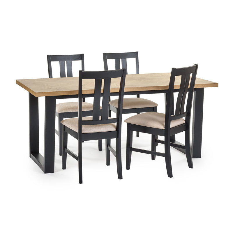 Dining table set with four black chairs on a white background