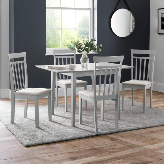 Dining room with a gray dining table and chairs on a wooden floor.