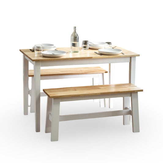 Wooden dining table with two benches on a white background