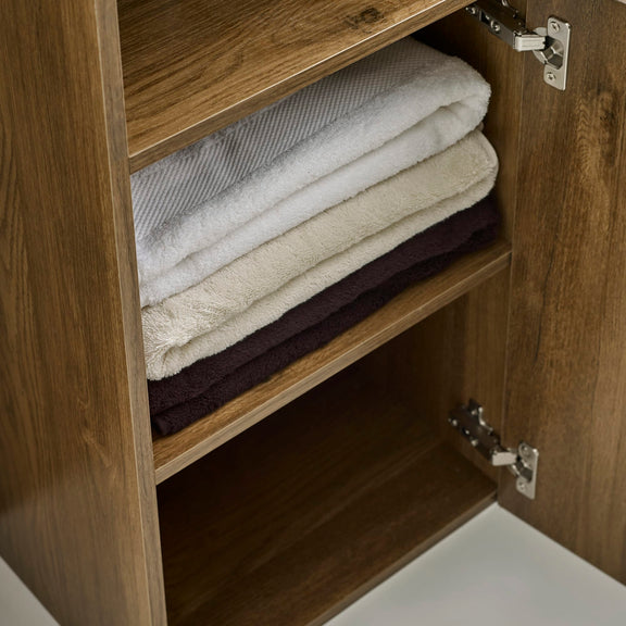 Stack of folded towels inside a wooden cabinet