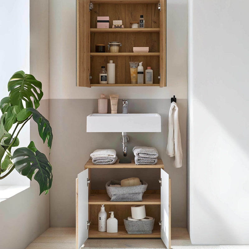 Bathroom with wooden cabinets, sink, and toiletries