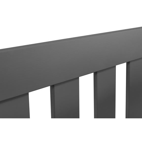 Close-up of a dark gray metal railing on a white background