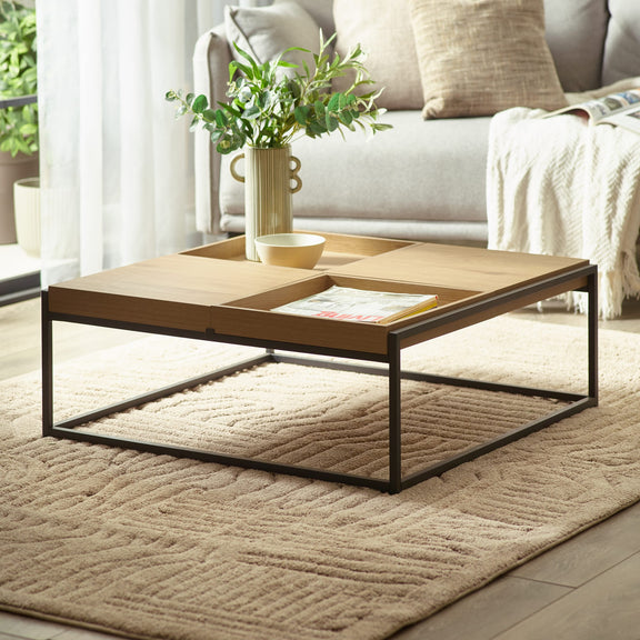 Coffee table with a plant and magazine in a living room setting