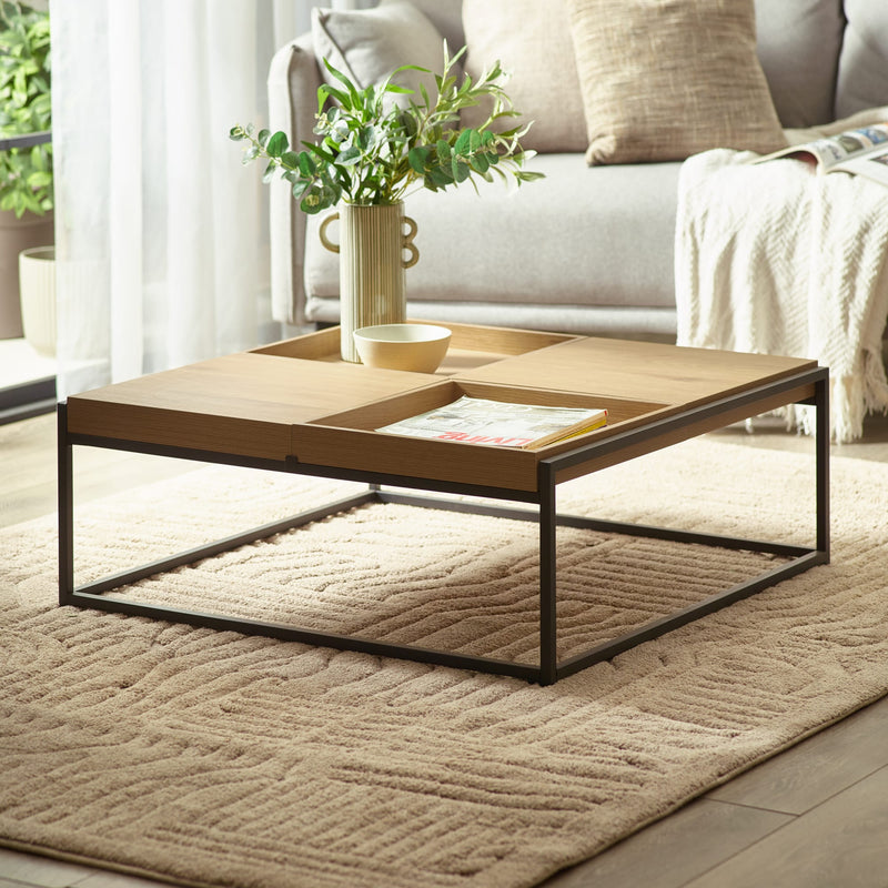 Coffee table with a plant and magazine in a living room setting