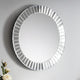 Round mirror with decorative frame on a gray background