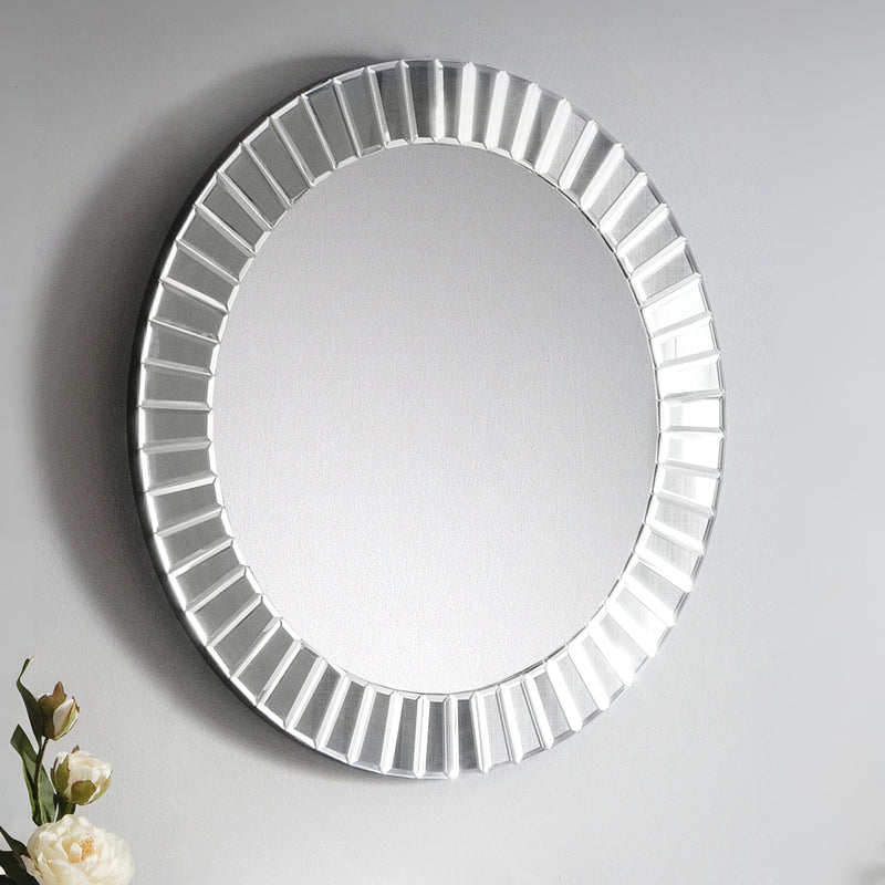Round mirror with decorative frame on a gray background