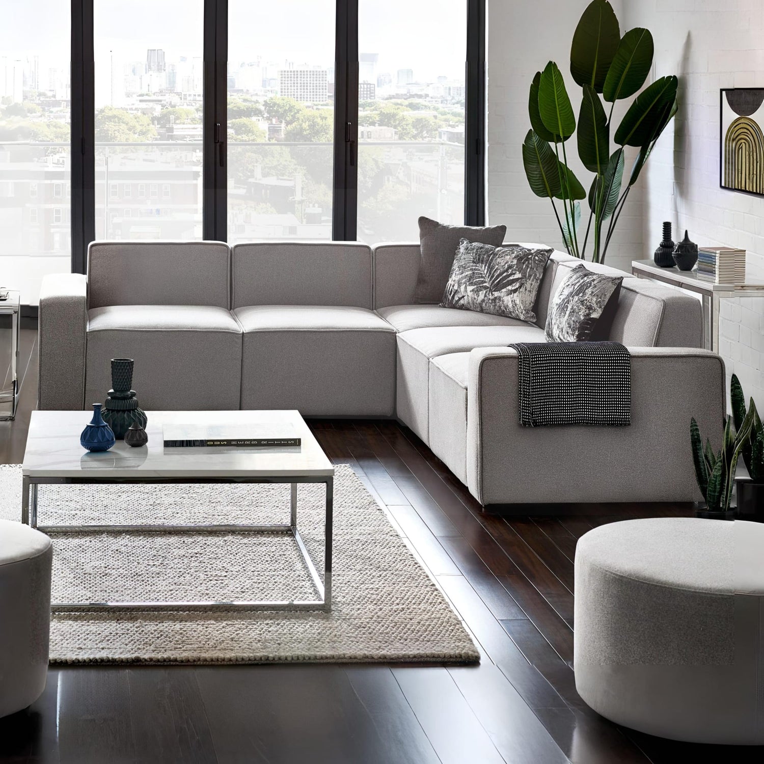 Modern living room with a sectional sofa, coffee table, and decorative items.