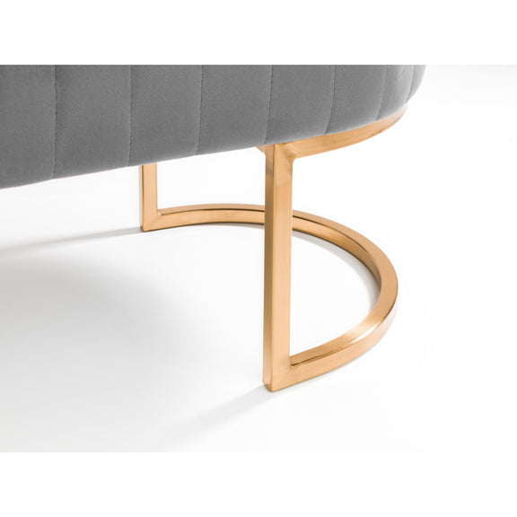 Gray cushioned chair with gold metal frame on a white background