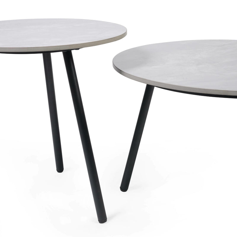 Two round tables with white tops and black legs on a white background