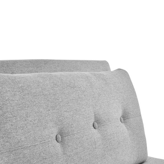 Gray upholstered headboard with tufted design on a white background