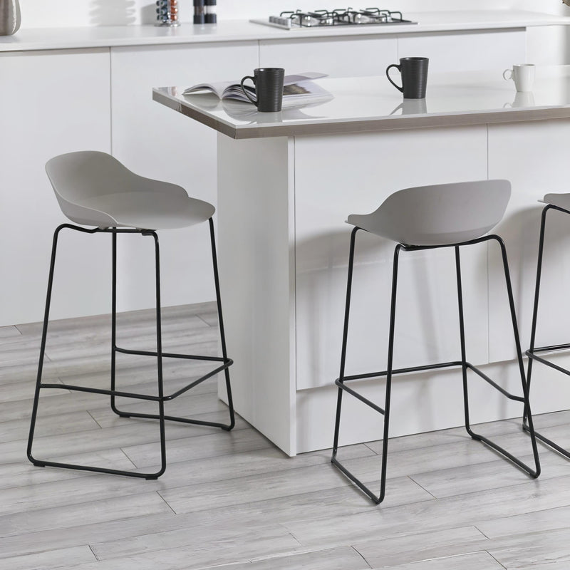 Gray bar stools with black legs in a kitchen setting