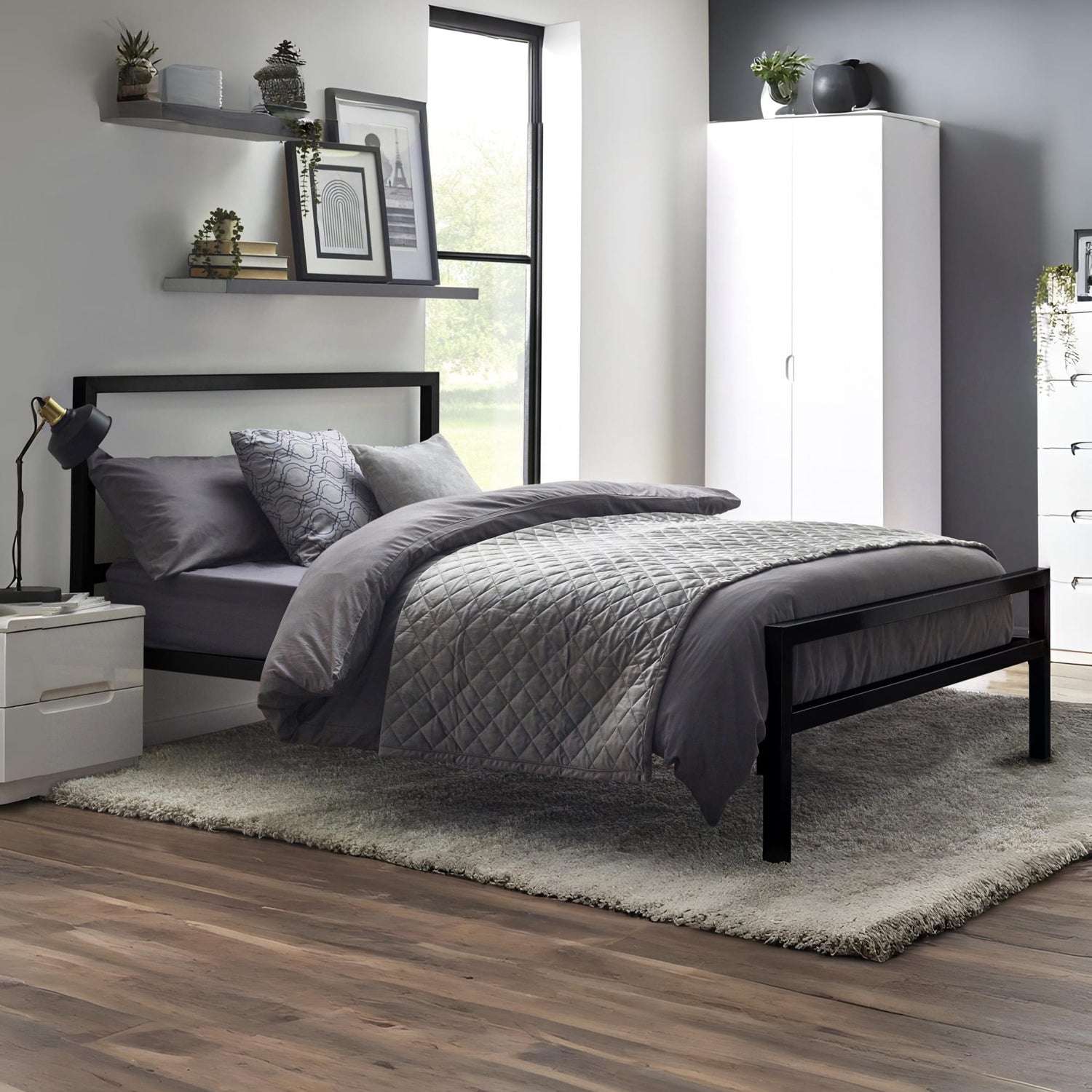 Modern bedroom with a black bed frame, gray bedding, and white wardrobe.