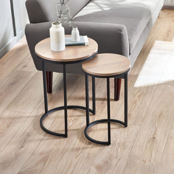 Two wooden side tables with black metal legs in a living room setting.