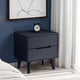 Black nightstand with a clock against a blue wall