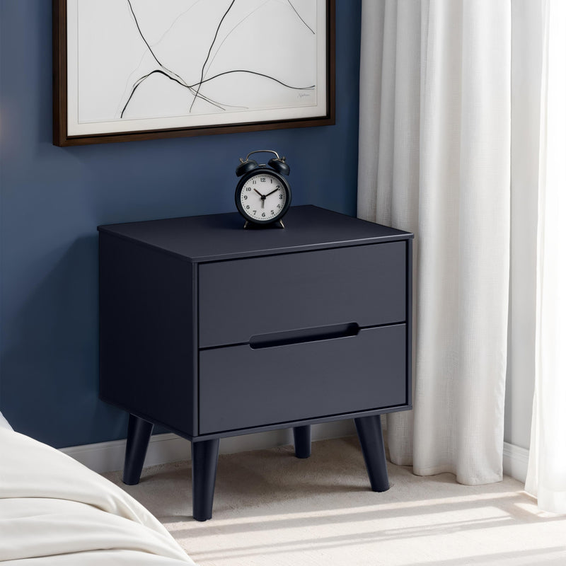 Black nightstand with a clock against a blue wall