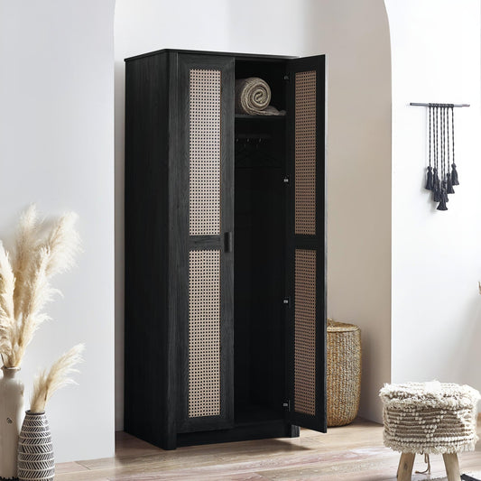 Black wardrobe with wicker doors in a room with decor elements.