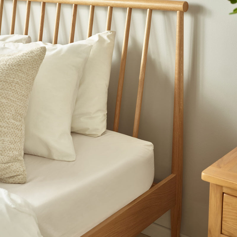 Wooden bench with cushions against a neutral wall