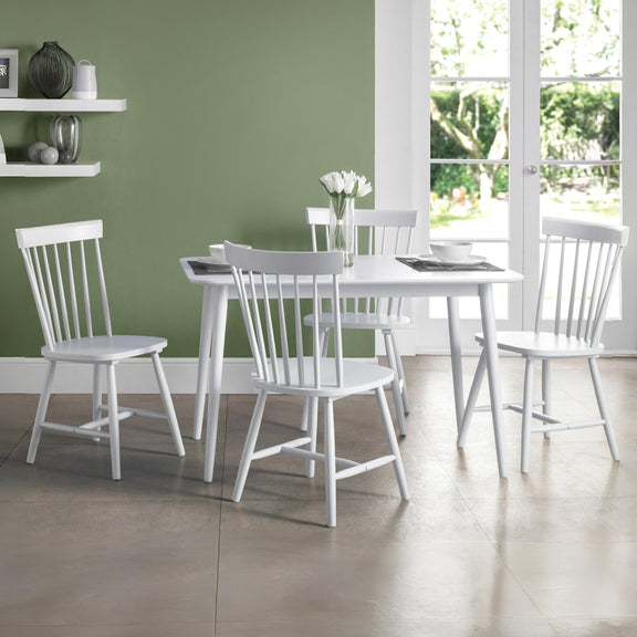 White dining set with table and chairs in a room with green walls and a window.