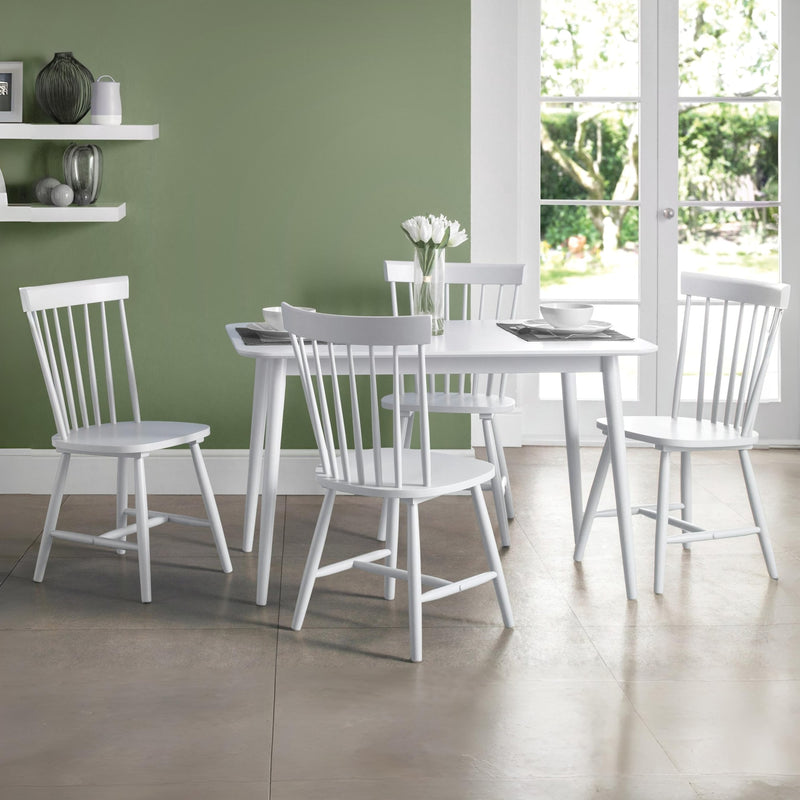 White dining set with table and chairs in a room with green walls and a window.