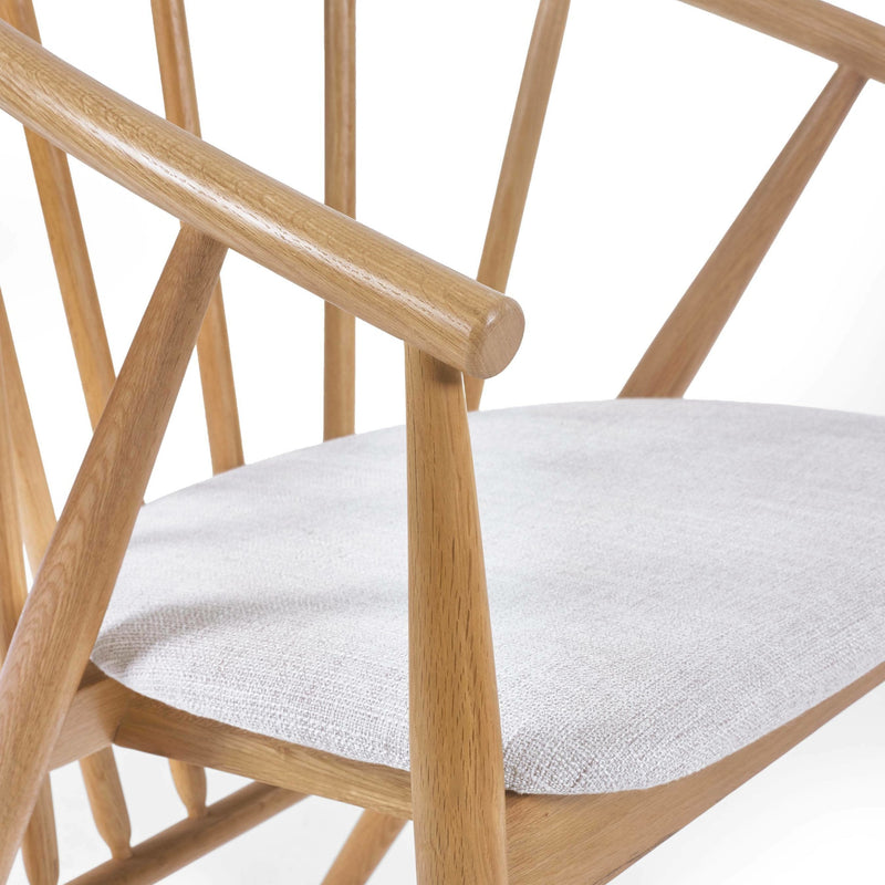 Wooden chair with a white cushion on a white background