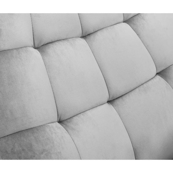 Close-up of a tufted gray upholstered headboard