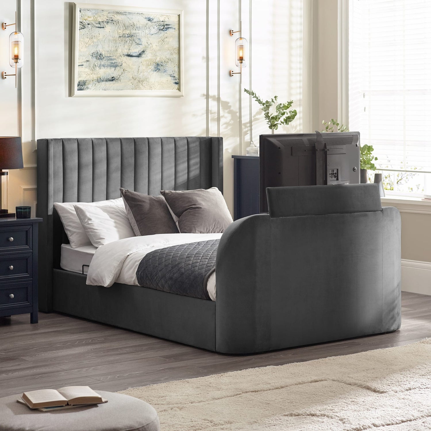 Gray upholstered bed in a bedroom setting with nightstands and decor.