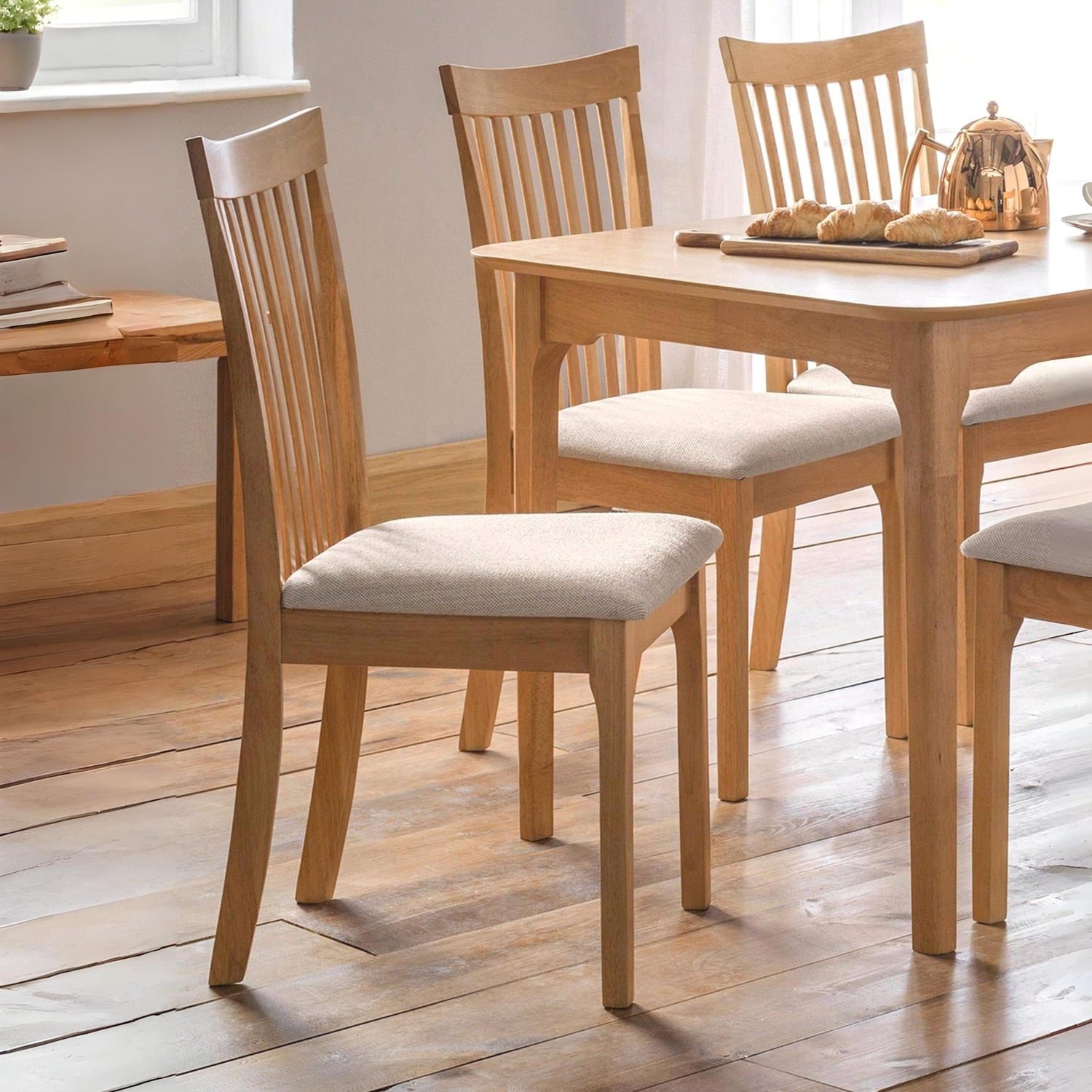 Wooden dining table with chairs on a wooden floor