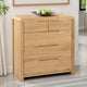Wooden dresser with four drawers in a room setting.