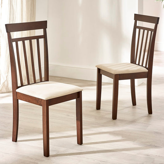 Two wooden chairs with white cushioned seats on a light wooden floor.